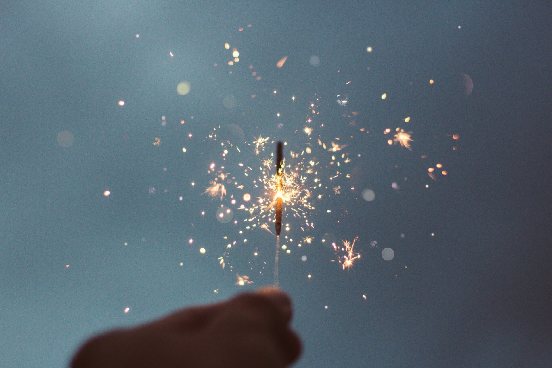 Story Consulting - a hand holding a sparkler