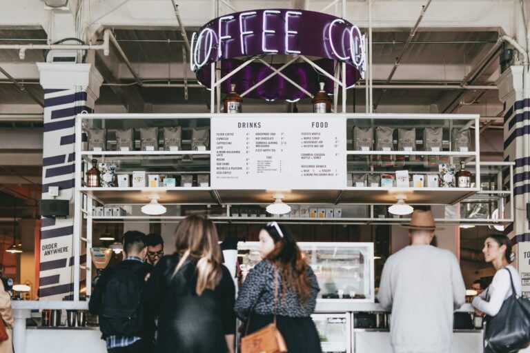 Story Consulting - a group of people standing in a coffee shop